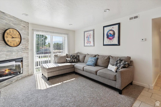 2631 W 5625 S, Roy, UT 84067 - living room featuring light tile patterned floors, a fireplace, baseboards, and a textured ceiling