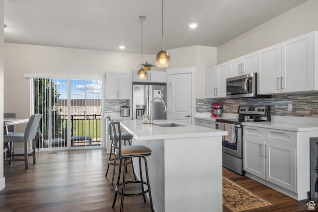1871 S 1030 W, Orem, UT 84058 - kitchen featuring appliances with stainless steel finishes, a sink, tasteful backsplash, a kitchen breakfast bar, and recessed lighting