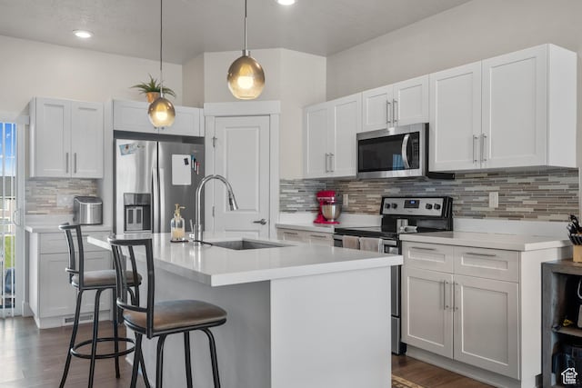 1871 S 1030 W, Orem, UT 84058 - kitchen featuring stainless steel appliances, a sink, a breakfast bar, decorative backsplash, and light countertops