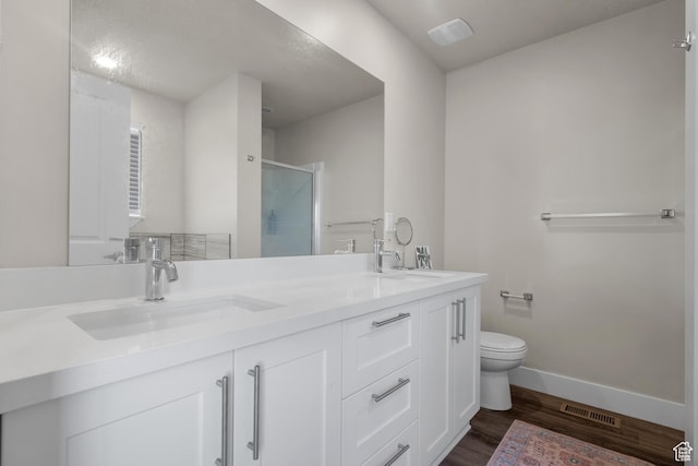 1871 S 1030 W, Orem, UT 84058 - bathroom featuring toilet, double vanity, a shower stall, baseboards, and wood finished floors