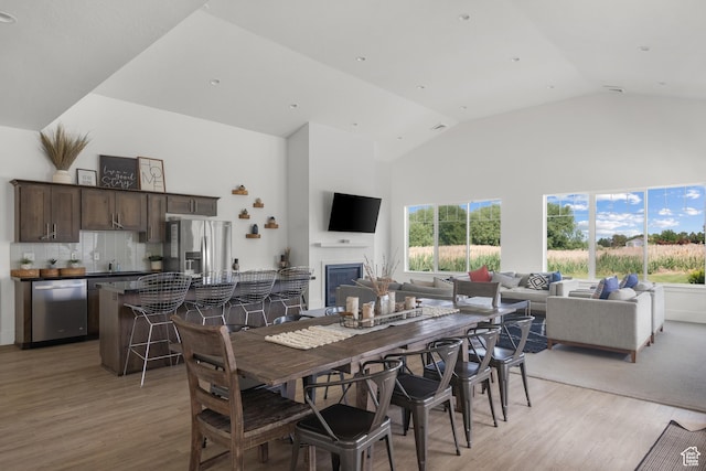 1871 S 1030 W, Orem, UT 84058 - dining space with high vaulted ceiling, light wood-type flooring, and a glass covered fireplace