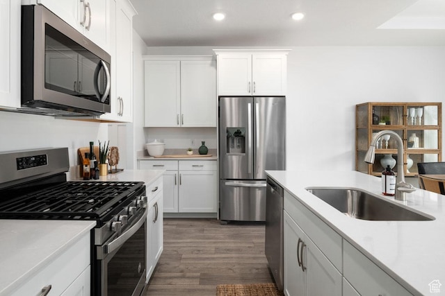 4111 W 1575 S Unit 118, Ogden, UT 84404 - kitchen with appliances with stainless steel finishes, a sink, recessed lighting, dark wood finished floors, and light countertops