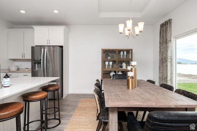 4111 W 1575 S Unit 118, Ogden, UT 84404 - dining area featuring wood finished floors, a chandelier, recessed lighting, a tray ceiling, and baseboards