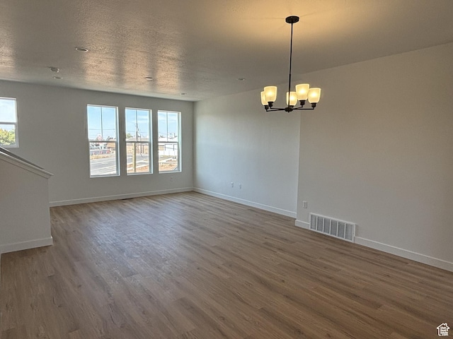 1650 N Main St N Unit 129, Layton, UT 84041 - spare room featuring wood finished floors, a chandelier, and baseboards