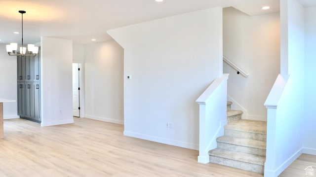 1650 N Main St N Unit 129, Layton, UT 84041 - staircase featuring wood finished floors, a chandelier, baseboards, and recessed lighting