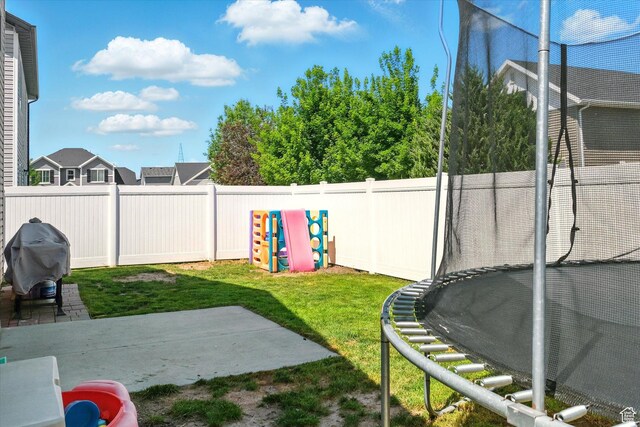 2124 S 1490 W, Wellsville, UT 84339 - fenced backyard with a trampoline and a patio