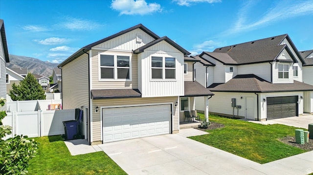 2124 S 1490 W, Wellsville, UT 84339 - view of front of home featuring board and batten siding, a garage, driveway, and a residential view