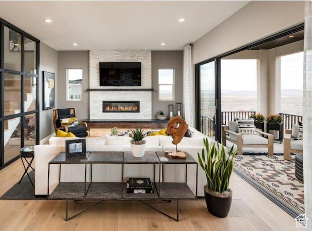 1298 W Sostice Dr Unit 335, Lehi, UT 84043 - living area featuring wood finished floors, a fireplace, and recessed lighting