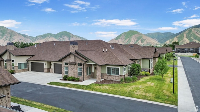 1736 W 300 S Unit D, Mapleton, UT 84664 - view of front of home featuring brick siding, a mountain view, a garage, concrete driveway, and a front yard