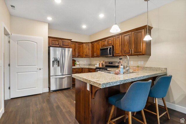 1736 W 300 S Unit D, Mapleton, UT 84664 - kitchen with appliances with stainless steel finishes, light countertops, a breakfast bar, a peninsula, and baseboards