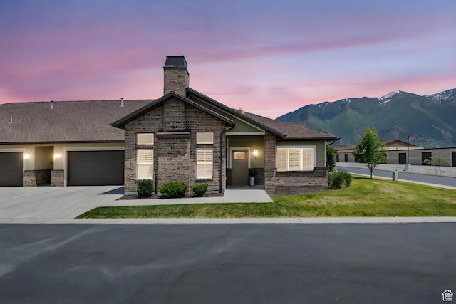 1736 W 300 S Unit D, Mapleton, UT 84664 - view of front of house featuring brick siding, a chimney, a mountain view, an attached garage, and a front yard
