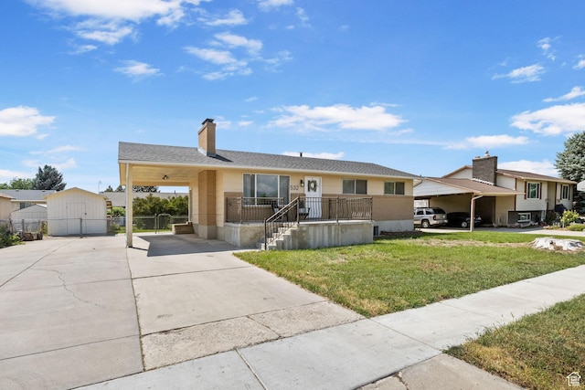 532 S 1500 E, Spanish Fork, UT 84660 - view of front facade featuring concrete driveway, an outdoor structure, a chimney, and a carport