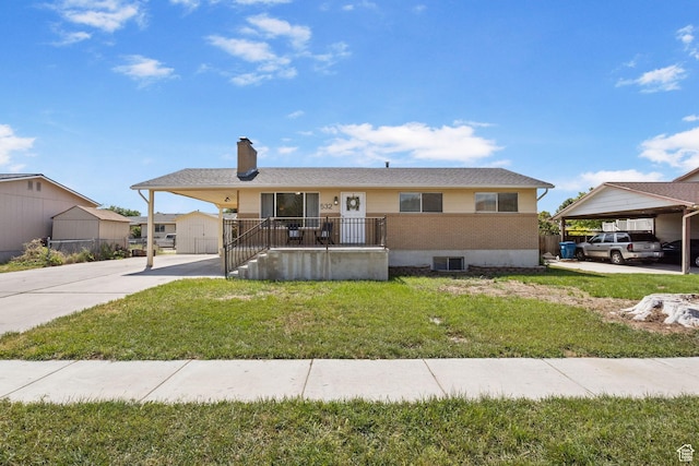 532 S 1500 E, Spanish Fork, UT 84660 - ranch-style house with a front lawn, a chimney, concrete driveway, and a carport
