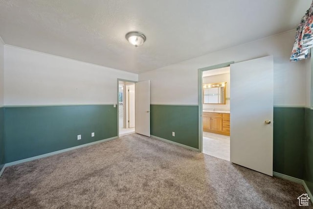 71 W Princeton Dr, Midvale, UT 84047 - unfurnished bedroom featuring carpet flooring, connected bathroom, and baseboards