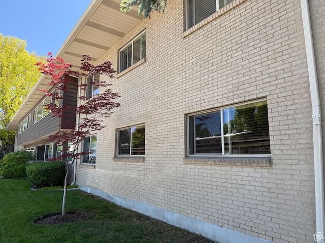 1132 E 2700 S Unit E36, Millcreek, UT 84106 - view of side of property featuring brick siding and a lawn