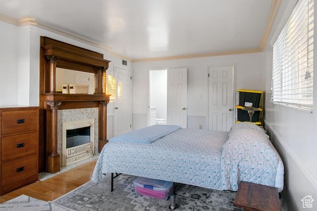 1132 E 2700 S Unit E36, Millcreek, UT 84106 - bedroom featuring wood finished floors, ornamental molding, and a tile fireplace