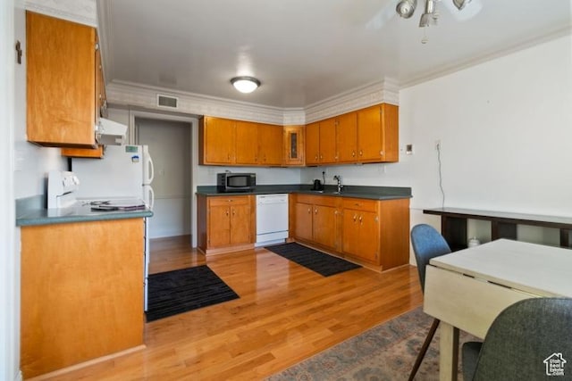 1132 E 2700 S Unit E36, Millcreek, UT 84106 - kitchen featuring white dishwasher, range hood, brown cabinetry, dark countertops, and light wood-style floors