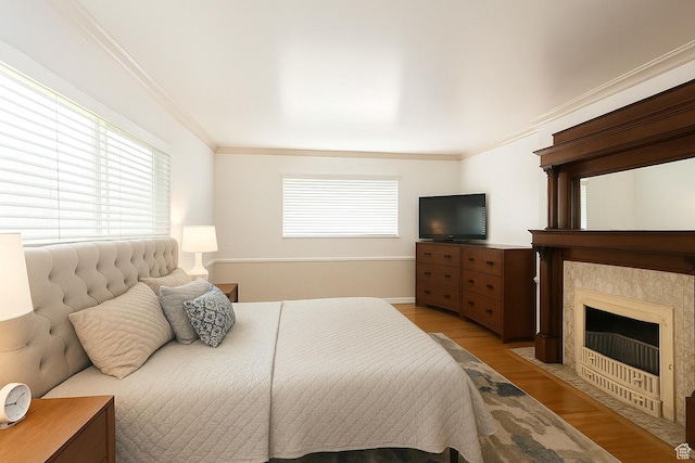 1132 E 2700 S Unit E36, Millcreek, UT 84106 - bedroom featuring light wood-style flooring, ornamental molding, and a high end fireplace
