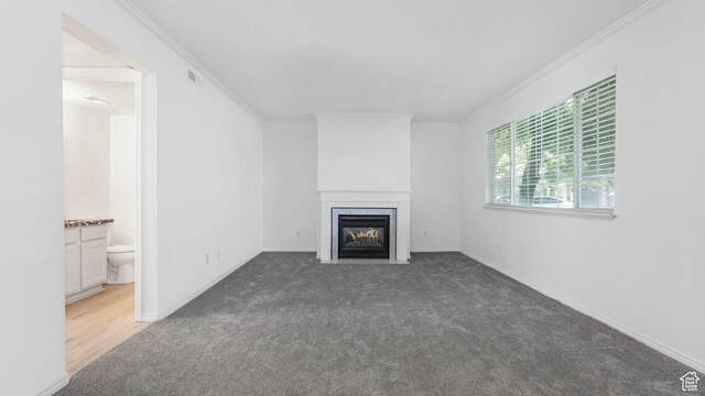 1833 W 7600 S Unit 419, West Jordan, UT 84084 - unfurnished living room with a fireplace with flush hearth, carpet floors, crown molding, and baseboards