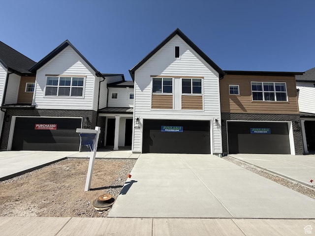 4586 W 3725 S Unit 239, West Haven, UT 84401 - view of front of home featuring a garage, driveway, and brick siding
