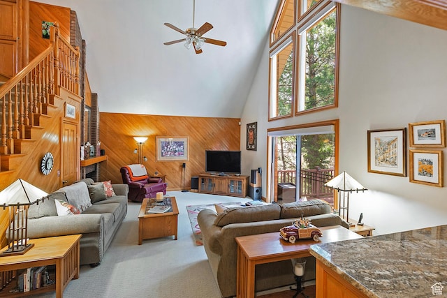 12144 S Mountain Shadow Rd, Sandy, UT 84092 - living room with high vaulted ceiling, a ceiling fan, wood walls, stairway, and light carpet
