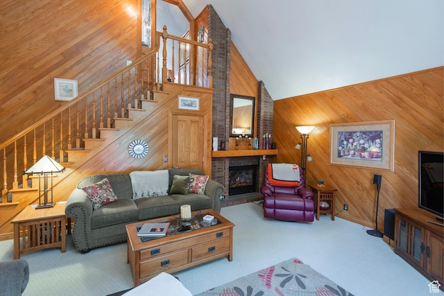 12144 S Mountain Shadow Rd, Sandy, UT 84092 - living area featuring high vaulted ceiling, wood walls, stairway, carpet flooring, and a brick fireplace