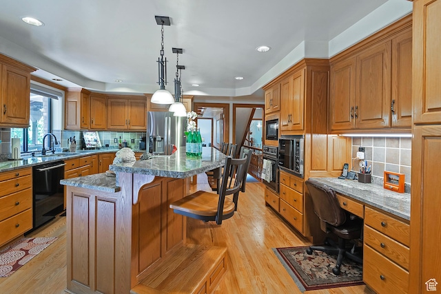 12144 S Mountain Shadow Rd, Sandy, UT 84092 - kitchen with black appliances, a sink, light wood finished floors, a center island, and backsplash