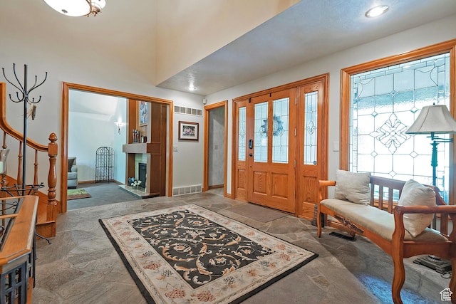 12144 S Mountain Shadow Rd, Sandy, UT 84092 - foyer entrance with plenty of natural light, stone finish flooring, a fireplace with raised hearth, baseboards, and recessed lighting