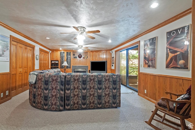 12144 S Mountain Shadow Rd, Sandy, UT 84092 - living area featuring light colored carpet, wooden walls, a wainscoted wall, a ceiling fan, and ornamental molding