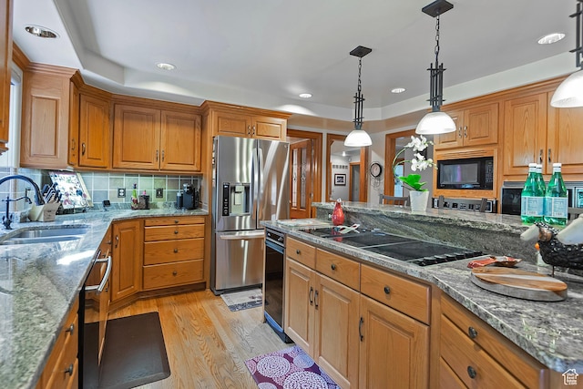 12144 S Mountain Shadow Rd, Sandy, UT 84092 - kitchen with appliances with stainless steel finishes, a sink, light wood-style floors, decorative backsplash, and brown cabinetry