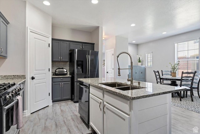 160 S 2875 W, West Point, UT 84015 - kitchen featuring a sink, light wood-type flooring, stainless steel appliances, light stone countertops, and recessed lighting