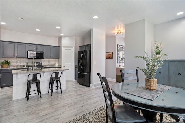 160 S 2875 W, West Point, UT 84015 - dining room featuring recessed lighting, light wood-style flooring, baseboards, and a textured ceiling