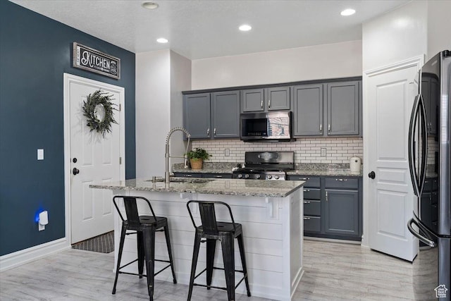 160 S 2875 W, West Point, UT 84015 - kitchen with range, stainless steel microwave, freestanding refrigerator, a sink, and light stone countertops