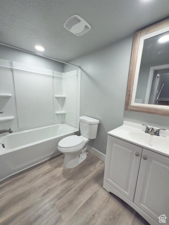 62 S 610 E, American Fork, UT 84003 - bathroom featuring vanity, bathtub / shower combination, recessed lighting, wood finished floors, and a textured ceiling