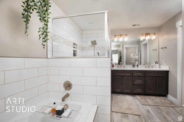 3516 N Willy Way, Eagle Mountain, UT 84005 - bathroom featuring double vanity, a garden tub, wood finished floors, and tiled shower