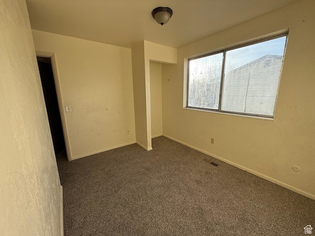 1035 W Wenco Dr, Salt Lake City, UT 84104 - unfurnished bedroom featuring dark carpet and baseboards