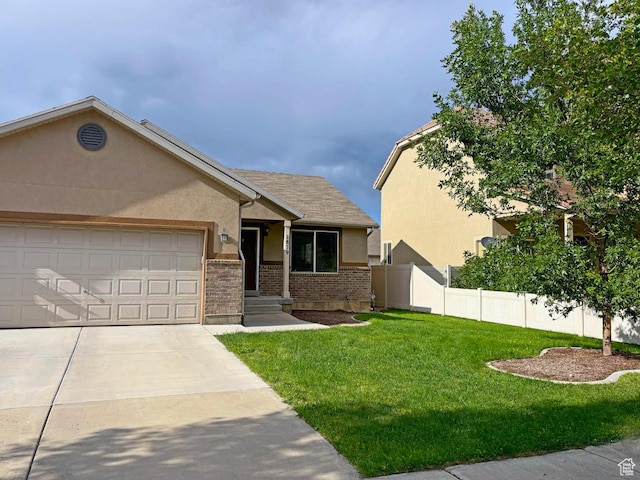 1879 E 1130 S, Spanish Fork, UT 84660 - view of front facade featuring stucco siding, a garage, driveway, and brick siding