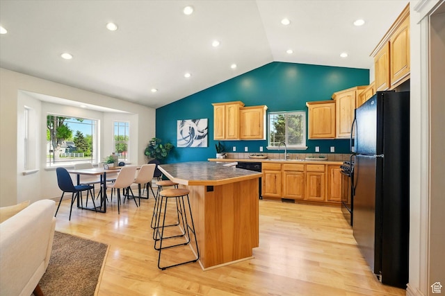 192 S 100 E, Wellsville, UT 84339 - kitchen with black appliances, a kitchen breakfast bar, a center island, light wood finished floors, and recessed lighting