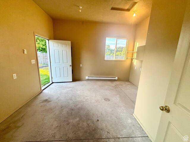 192 S 100 E, Wellsville, UT 84339 - empty room featuring baseboard heating, unfinished concrete floors, and attic access