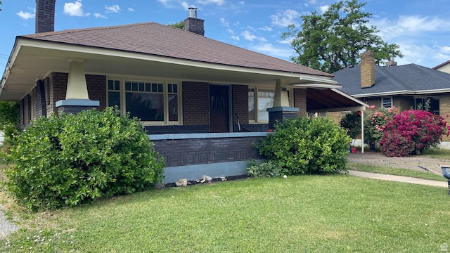 248 E 300 S, Springville, UT 84663 - view of front facade with a chimney, a front lawn, brick siding, and covered porch