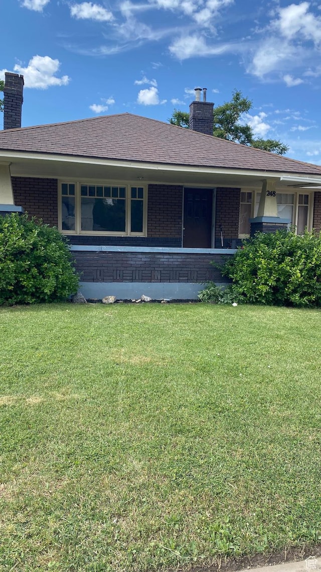 248 E 300 S, Springville, UT 84663 - rear view of house featuring a chimney, brick siding, and a lawn