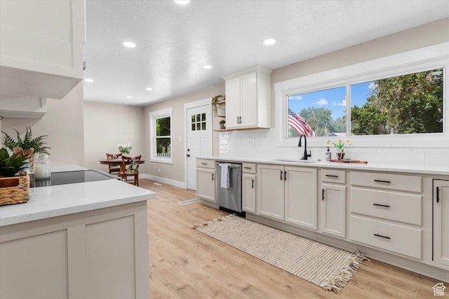 496 N 500 E, Nephi, UT 84648 - kitchen with stainless steel dishwasher, a sink, tasteful backsplash, light countertops, and light wood finished floors