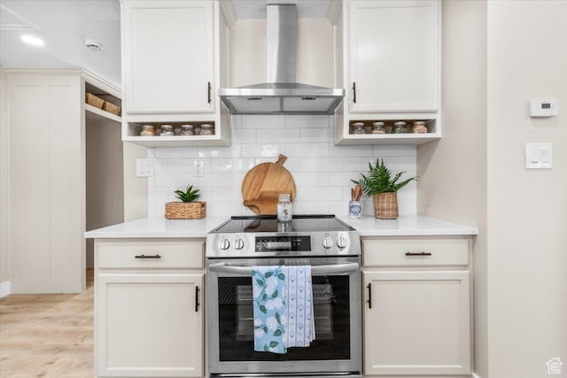 496 N 500 E, Nephi, UT 84648 - kitchen featuring stainless steel range with electric stovetop, wall chimney range hood, open shelves, tasteful backsplash, and light wood-type flooring