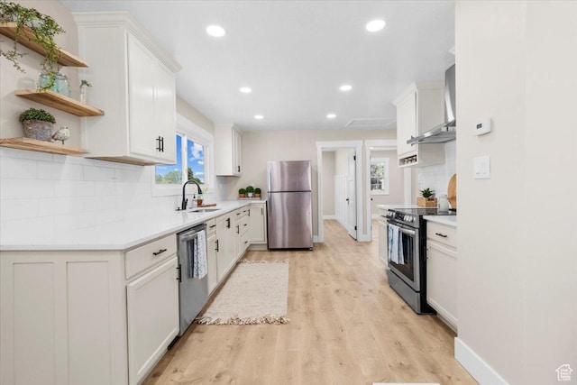 496 N 500 E, Nephi, UT 84648 - kitchen featuring appliances with stainless steel finishes, wall chimney range hood, open shelves, a sink, and recessed lighting