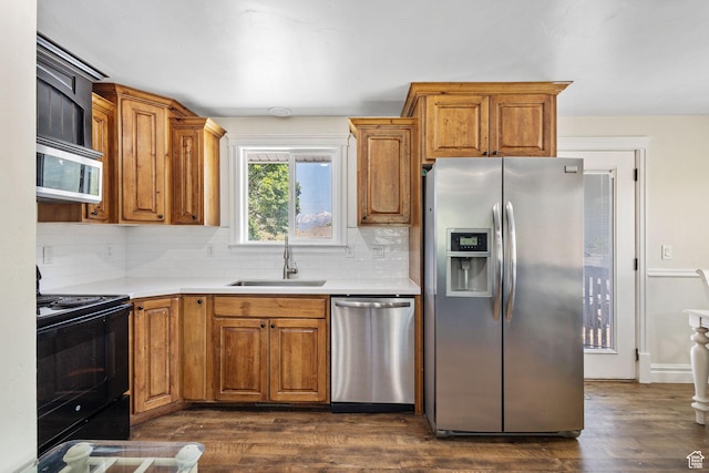 830 W 630 N, Orem, UT 84057 - kitchen with appliances with stainless steel finishes, a sink, tasteful backsplash, and brown cabinetry