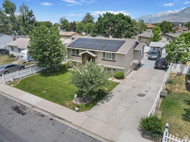 830 W 630 N, Orem, UT 84057 - view of front facade with a residential view, roof mounted solar panels, driveway, and a mountain view