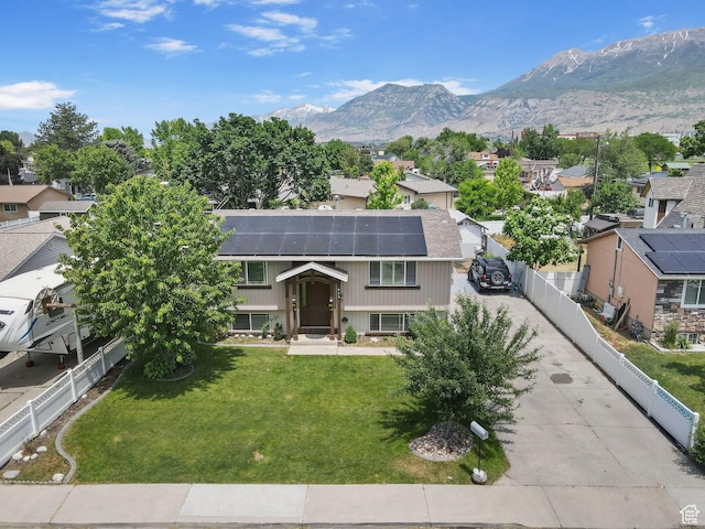 830 W 630 N, Orem, UT 84057 - split foyer home featuring a residential view, roof mounted solar panels, a mountain view, and concrete driveway