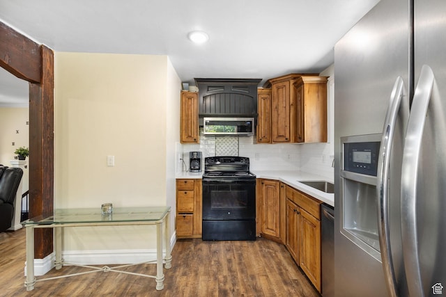 830 W 630 N, Orem, UT 84057 - kitchen featuring appliances with stainless steel finishes, dark wood finished floors, tasteful backsplash, light countertops, and brown cabinetry