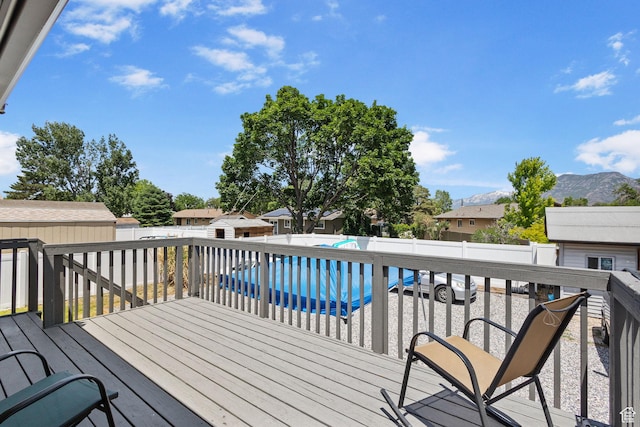 830 W 630 N, Orem, UT 84057 - wooden terrace featuring a fenced backyard, a mountain view, and an outbuilding