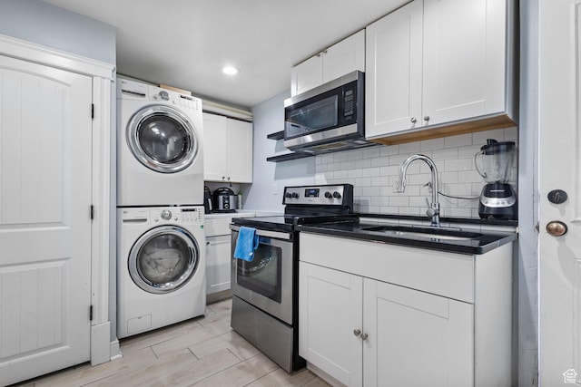 830 W 630 N, Orem, UT 84057 - laundry room with stacked washing machine and dryer, light wood finished floors, and recessed lighting
